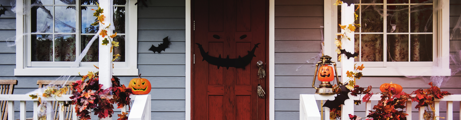 A door with a carved pumpkin and a bird on it.