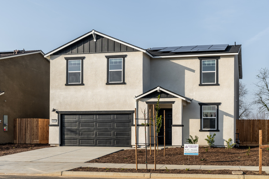 A grey house with a garage.