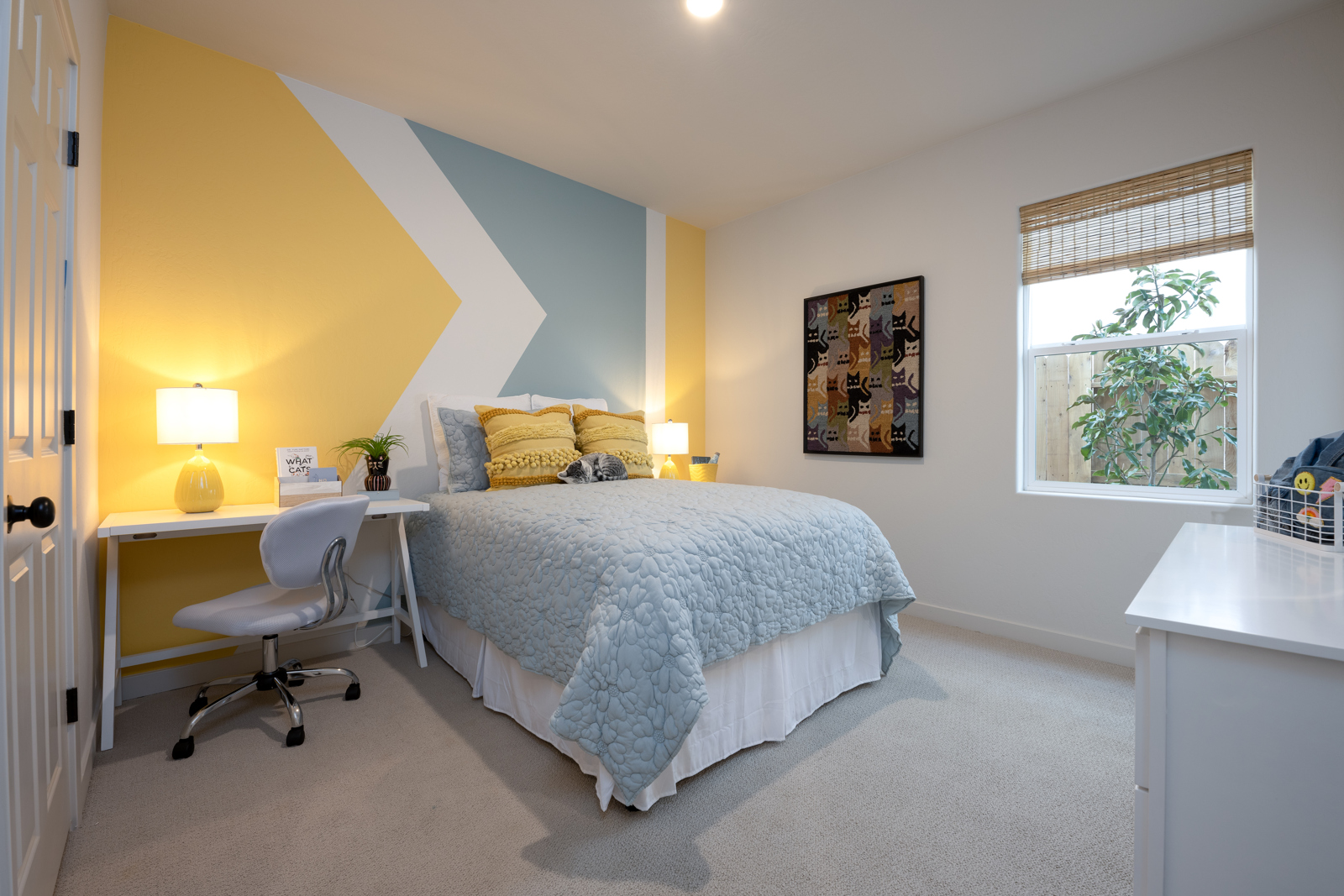 A bedroom with a bed and desk.