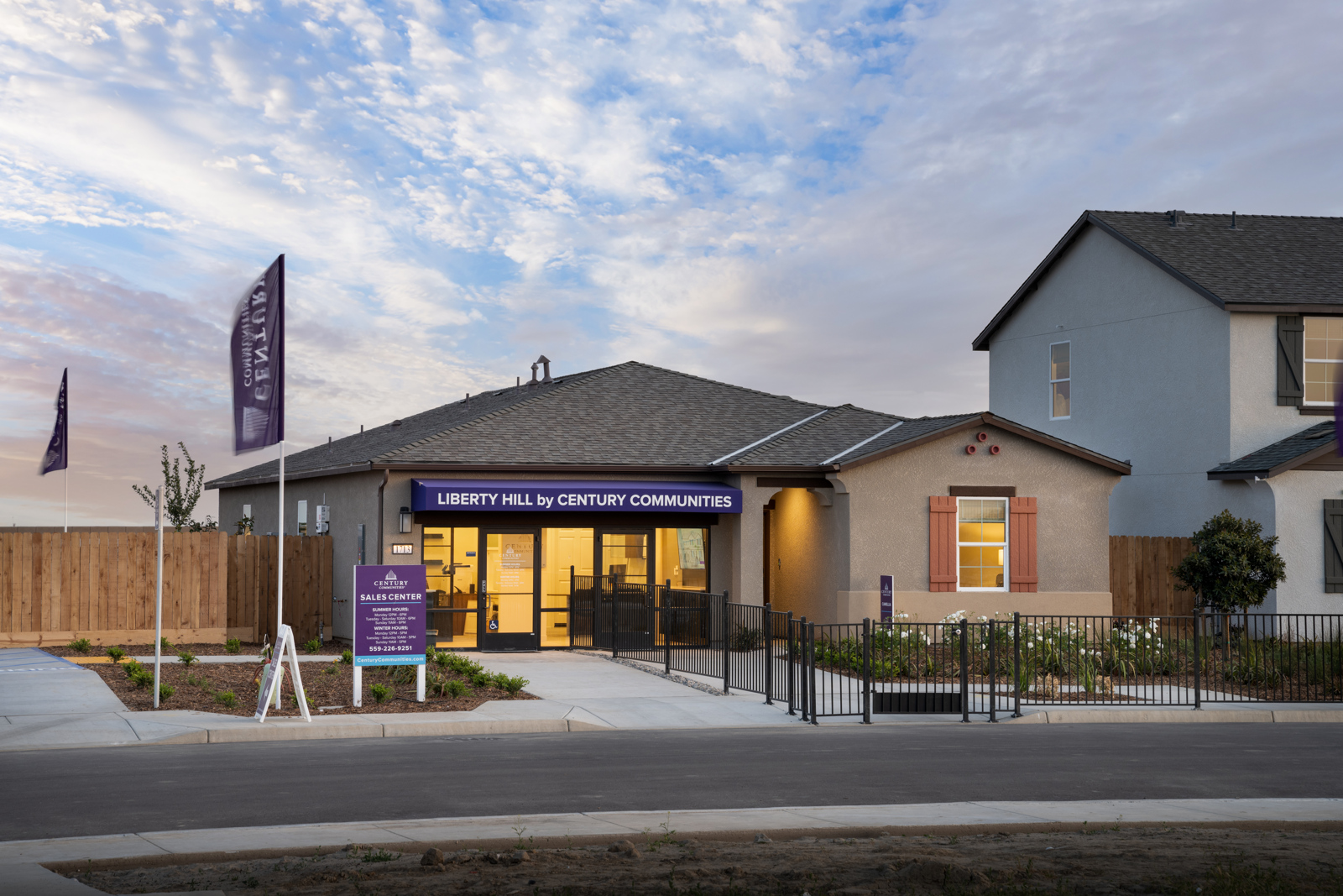 A building with a gate and a flag in front of it.