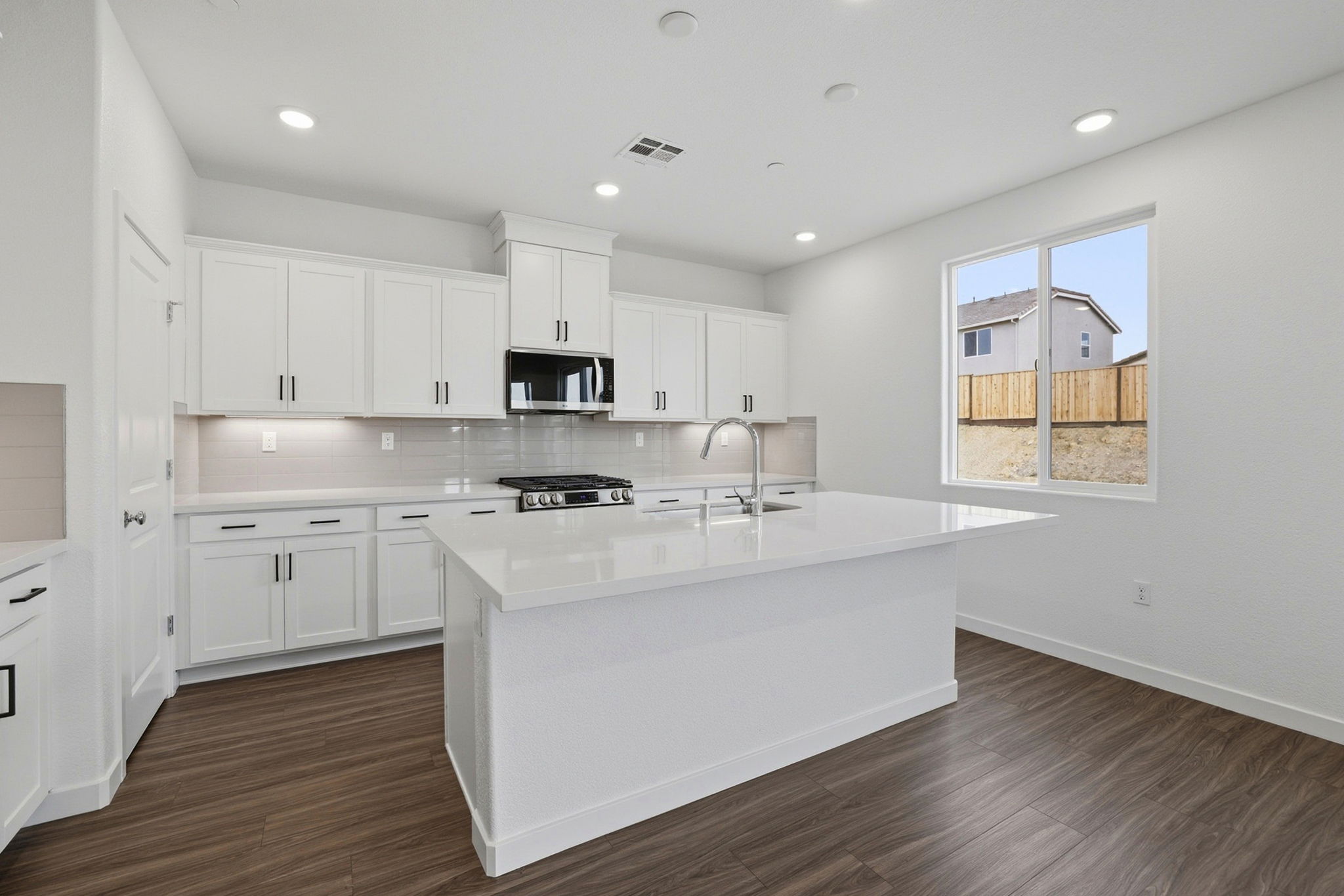 A kitchen with white cabinets.