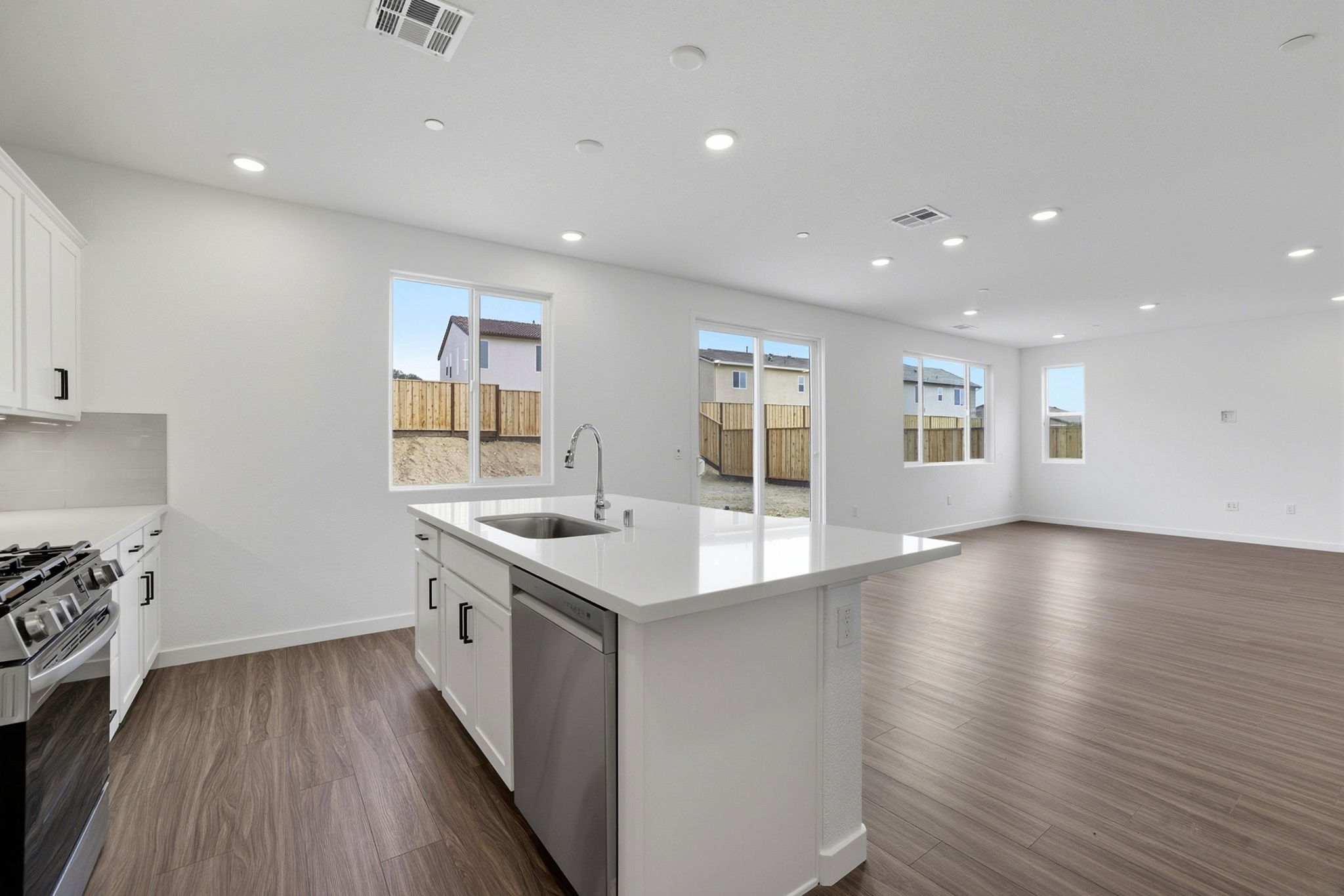 A kitchen with white cabinets.