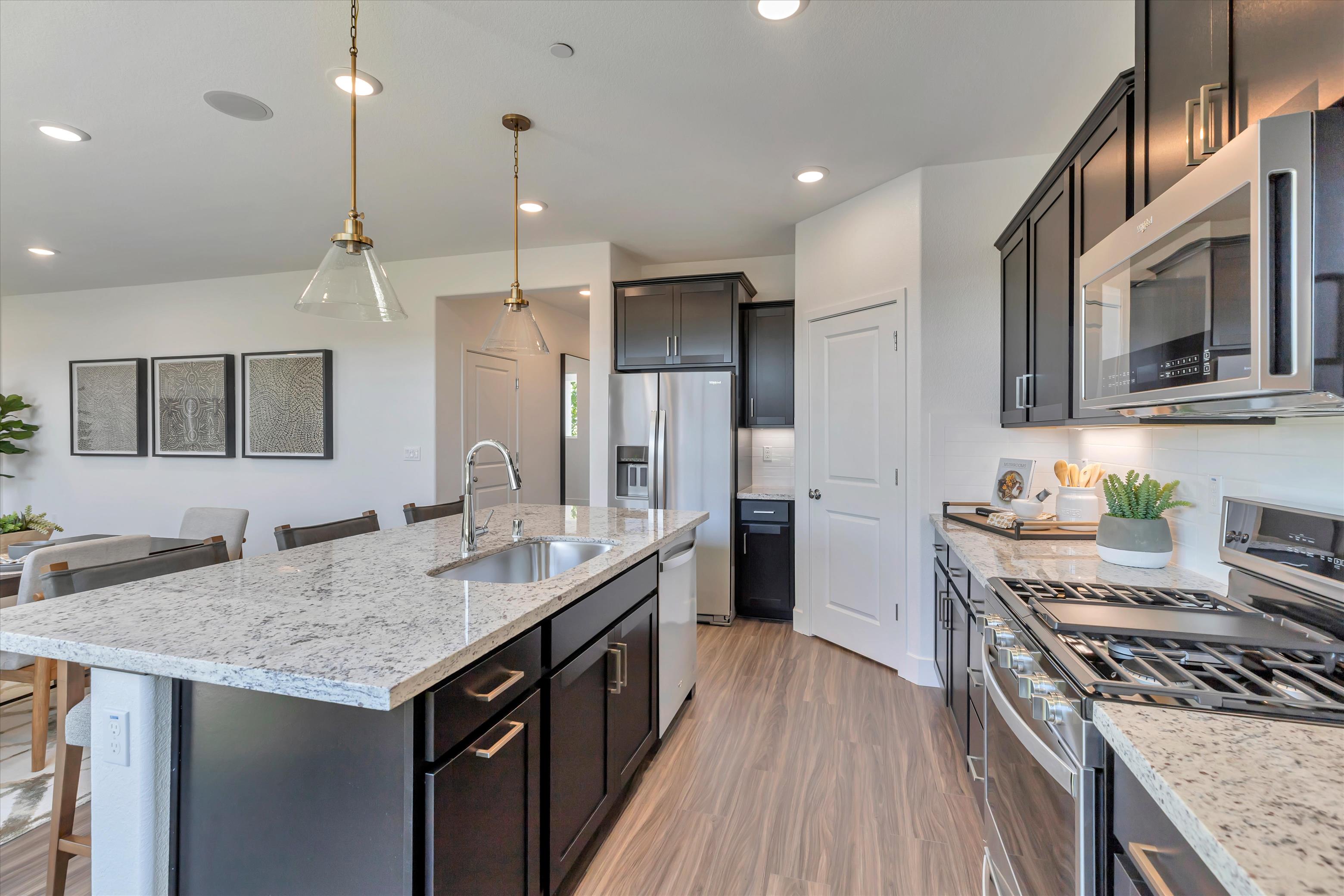 A kitchen with black cabinets.