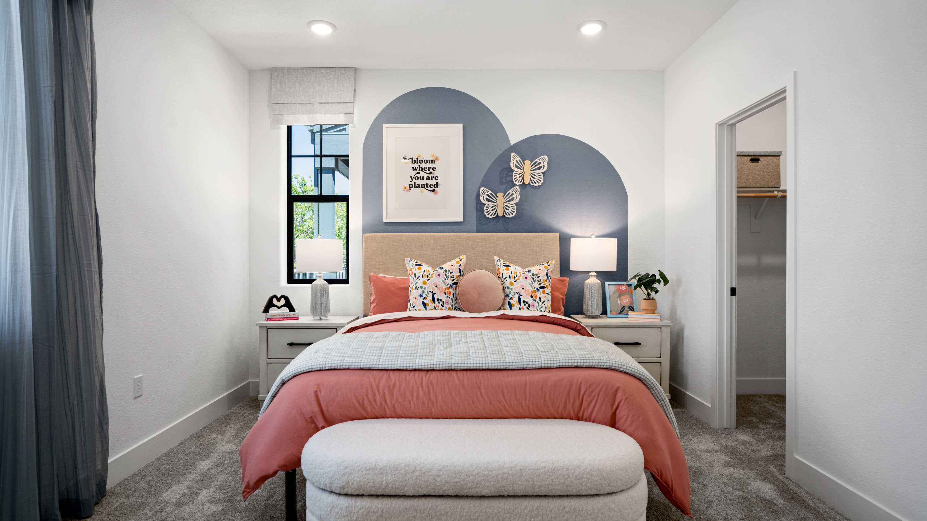 A bedroom with a bed and a window.