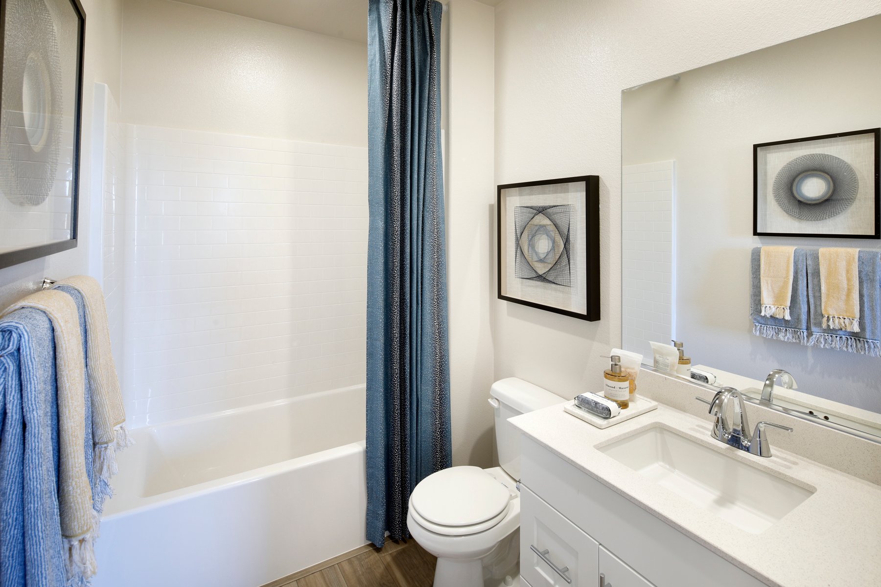 A bathroom with a sink toilet and bathtub.