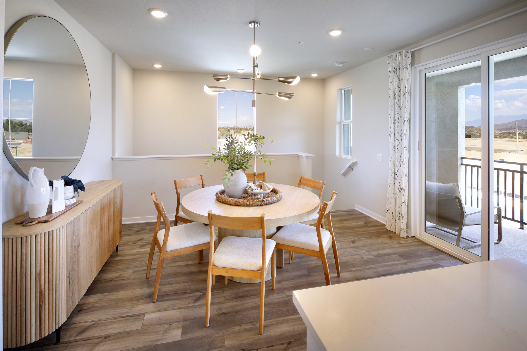 A dining room with a table and chairs.