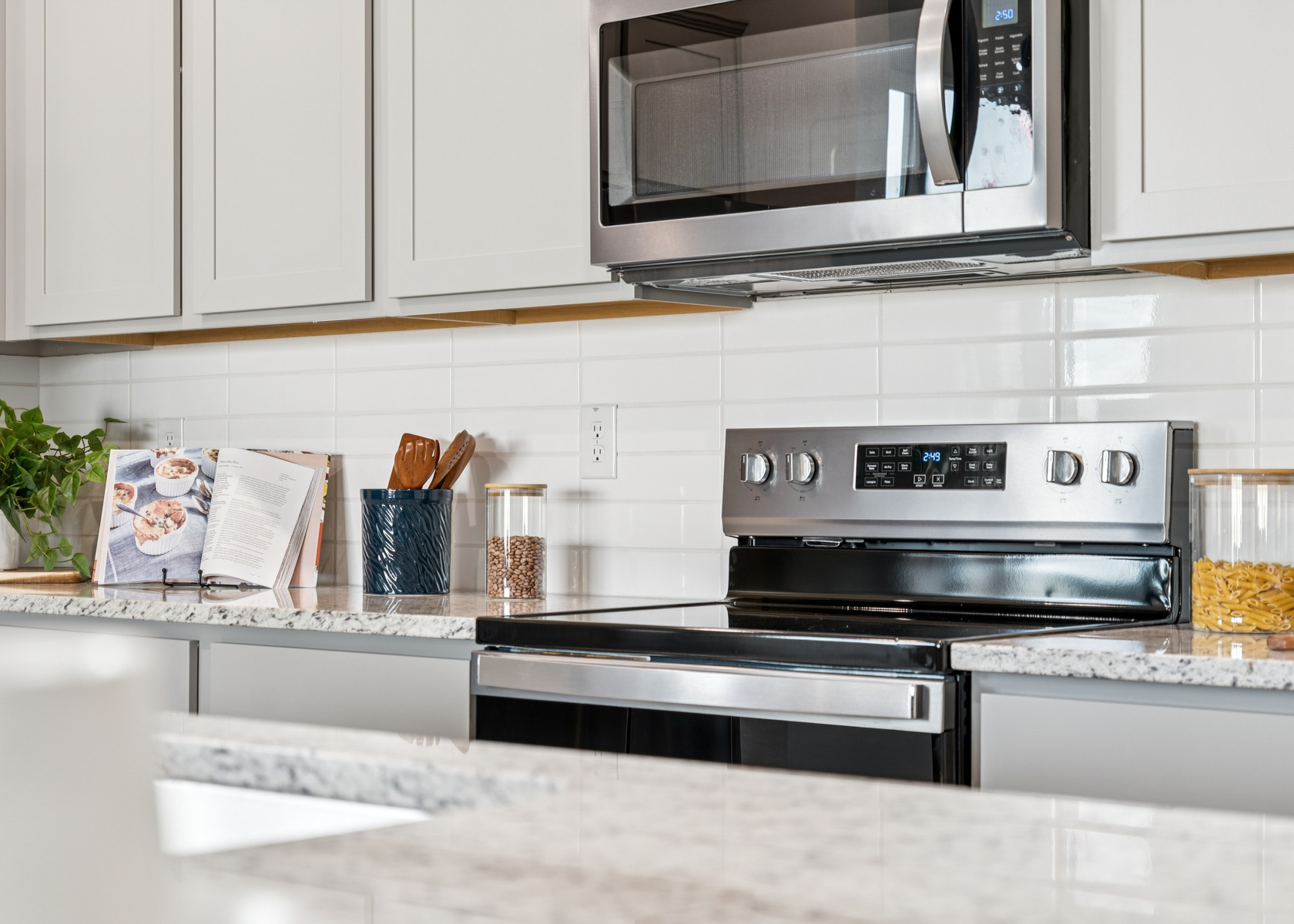 A kitchen with white cabinets.