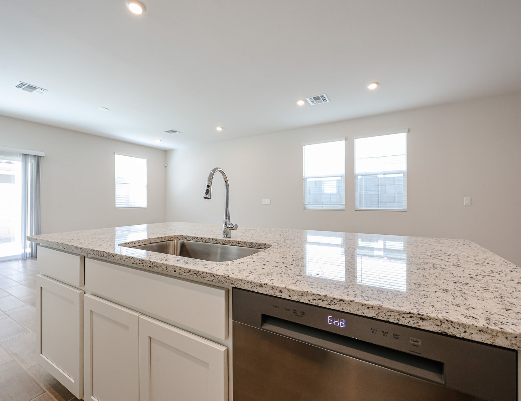 A kitchen with marble counters.