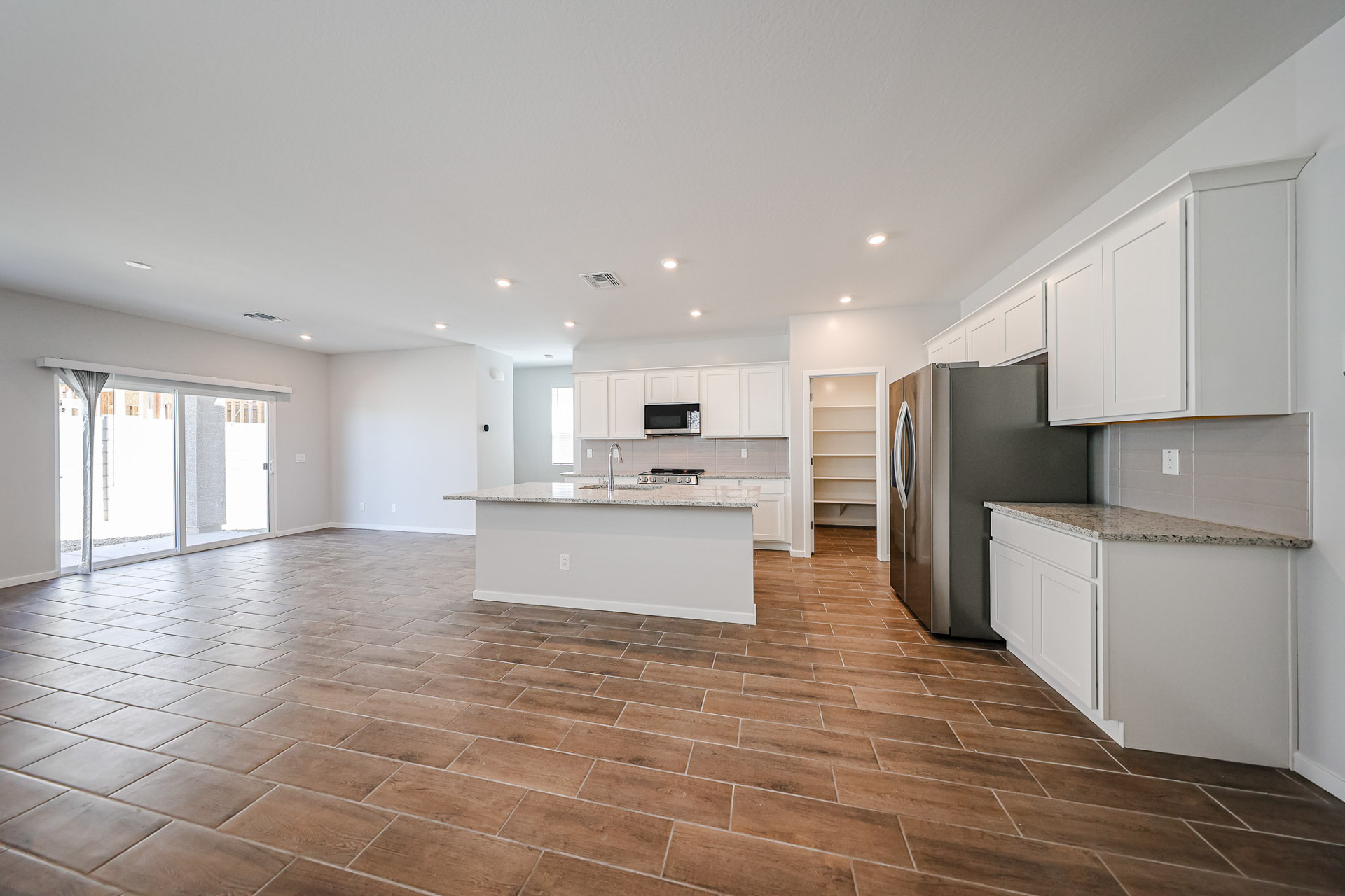 A large kitchen with white cabinets.