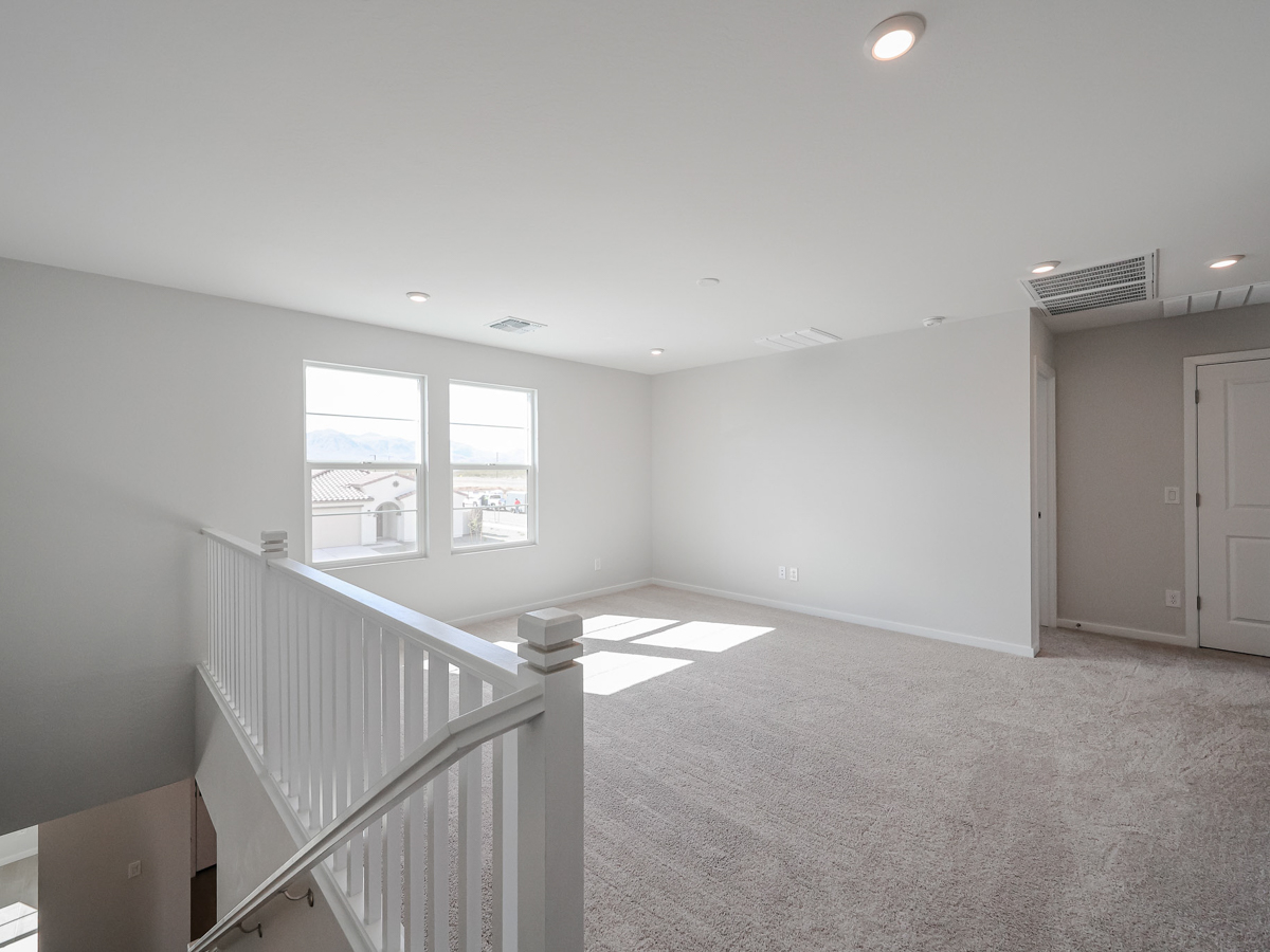 A room with a staircase and windows.