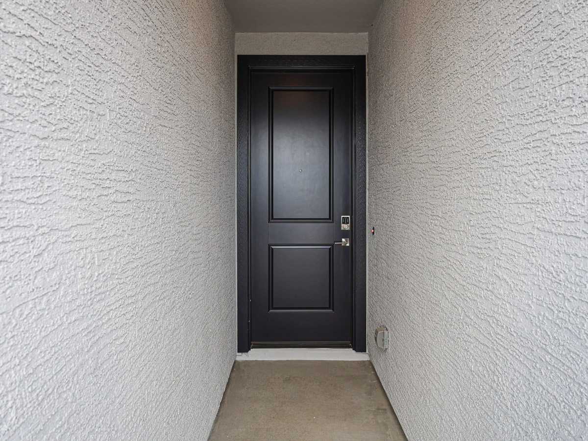A black door in a white room.