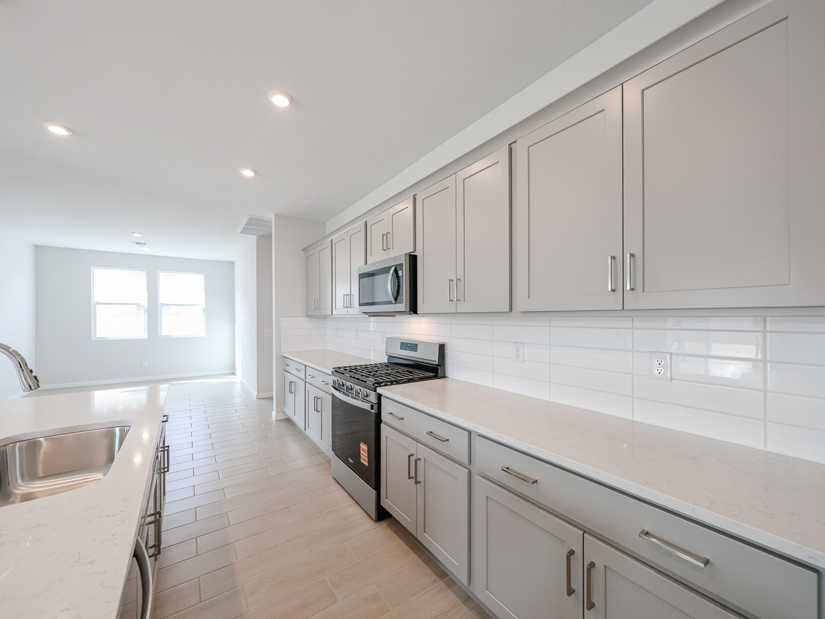 A kitchen with white cabinets.