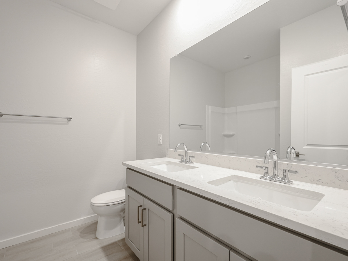 A bathroom with a large mirror.