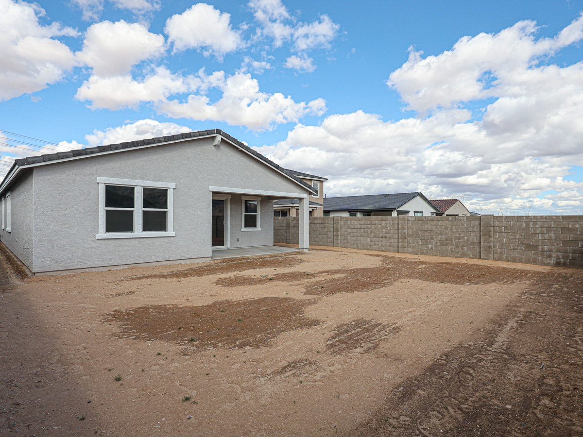 A house in a dirt field.