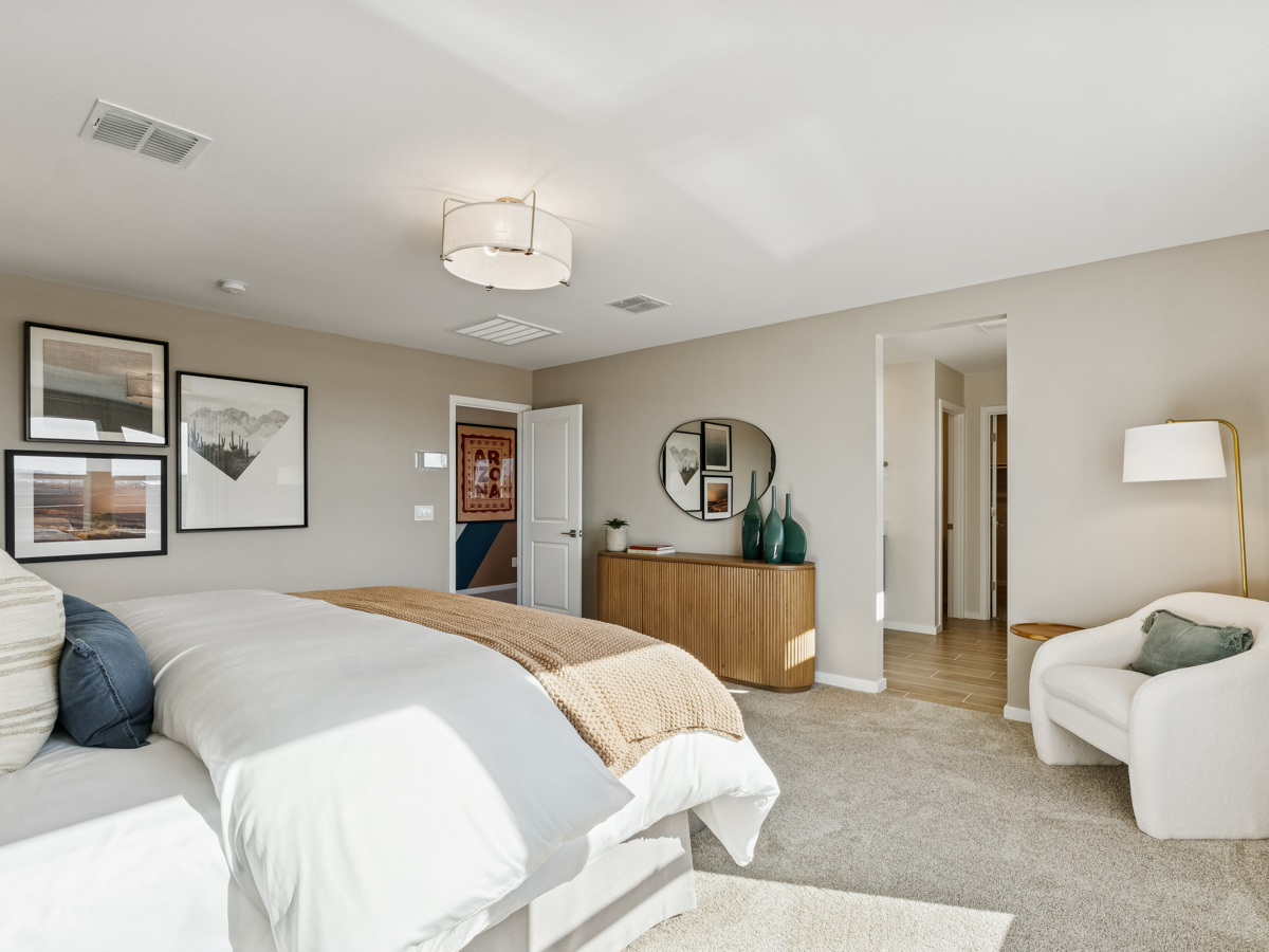 A bedroom with a bed and a mirror.