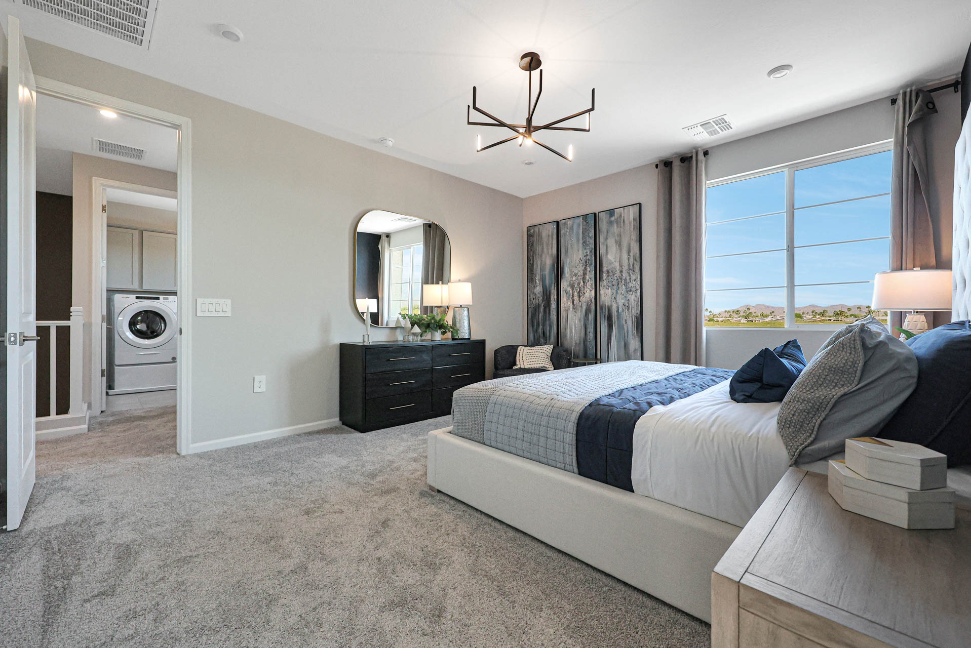 A bedroom with a bed and a mirror.