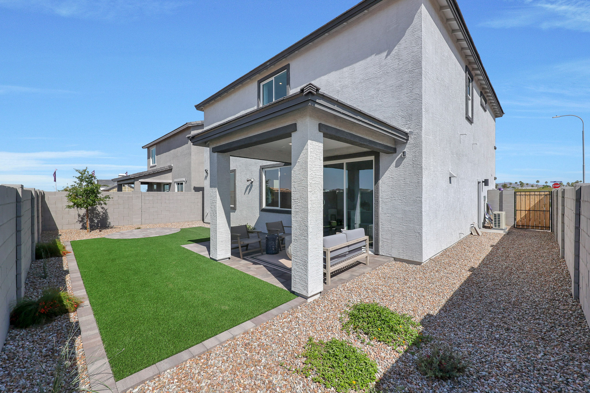 A house with a stone driveway.