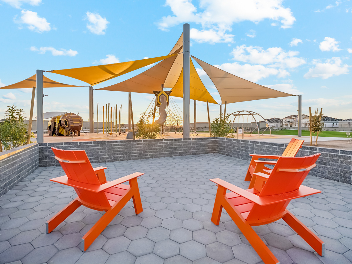 A couple of chairs on a patio.