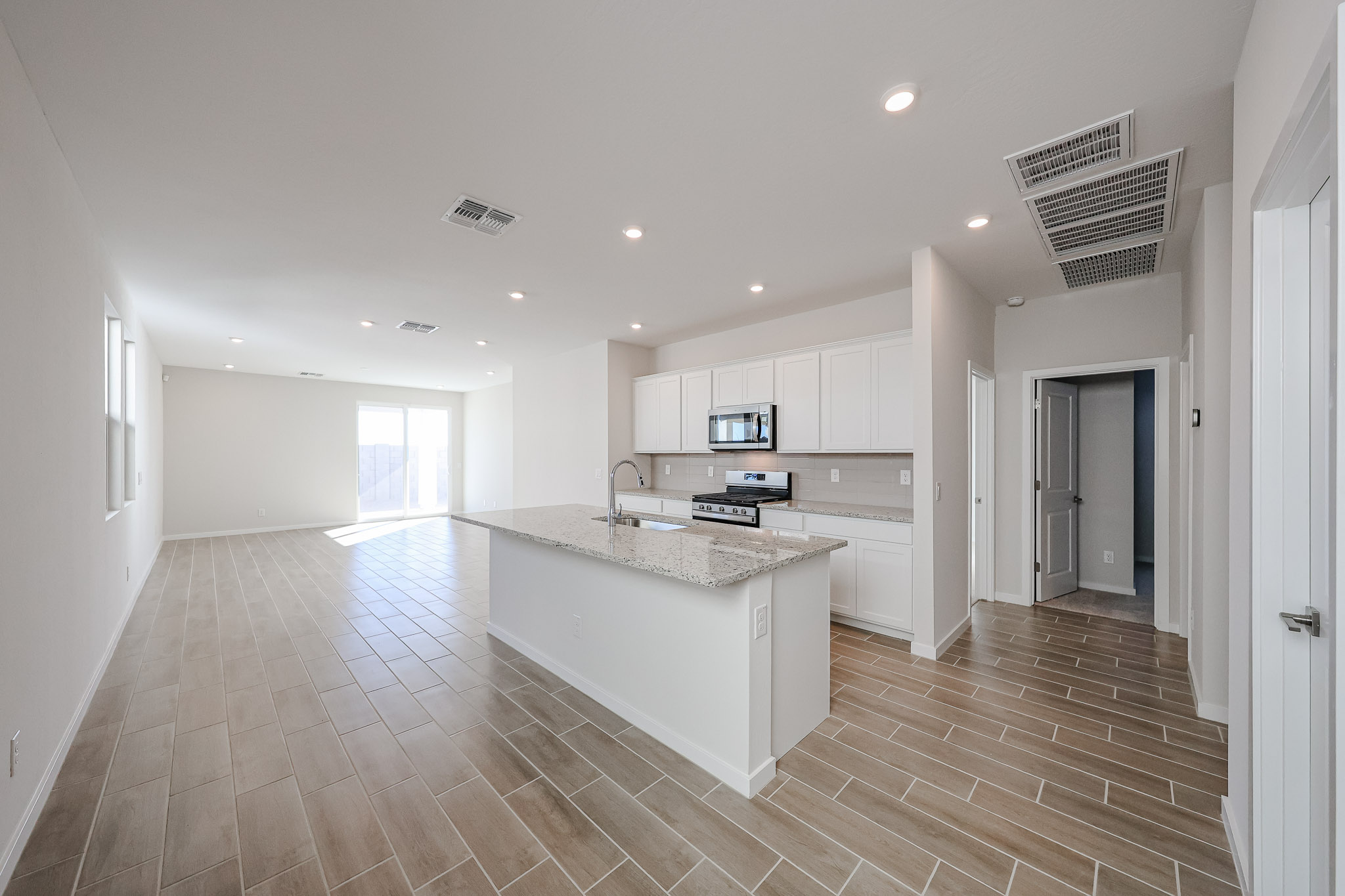 A kitchen with white cabinets.