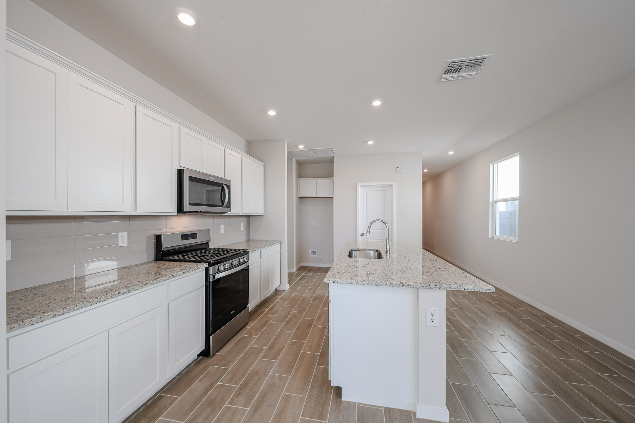 A kitchen with white cabinets.