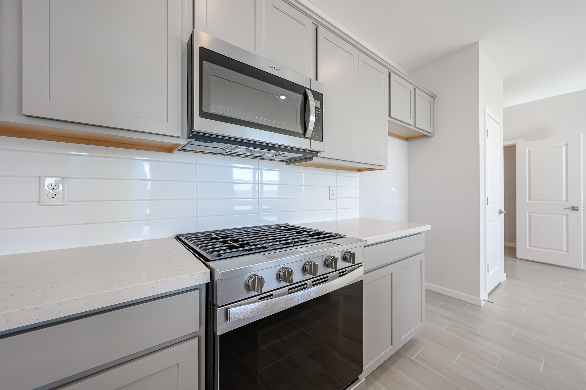 A kitchen with white cabinets.