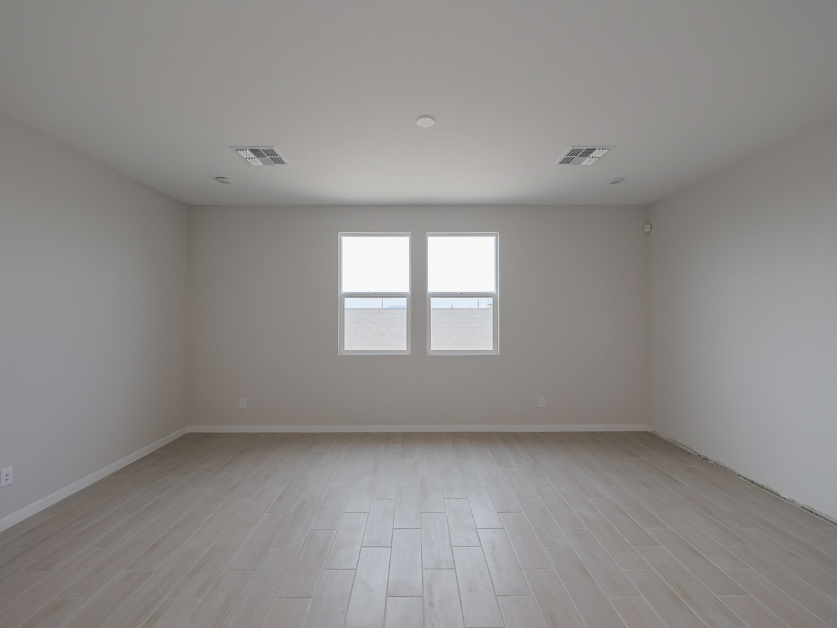 A room with a wood floor and a window.