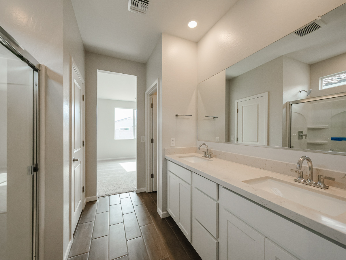A bathroom with white cabinets.