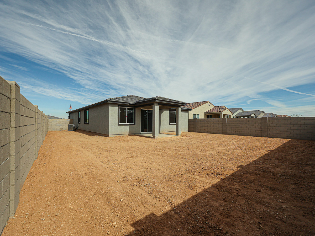 A dirt road leading to a row of houses.