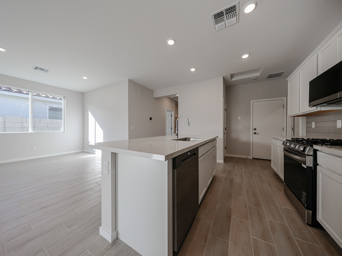 A kitchen with white cabinets.