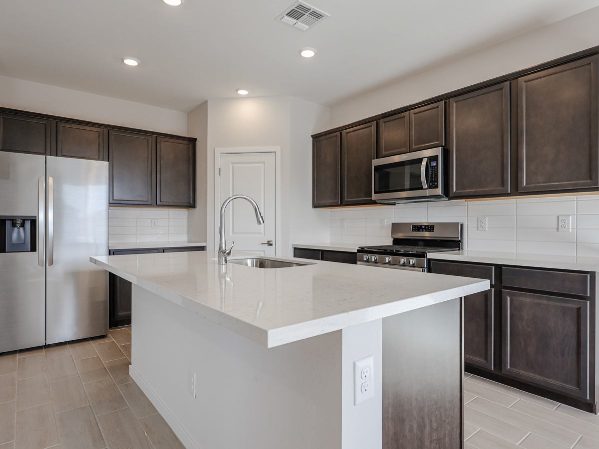 A kitchen with black cabinets.