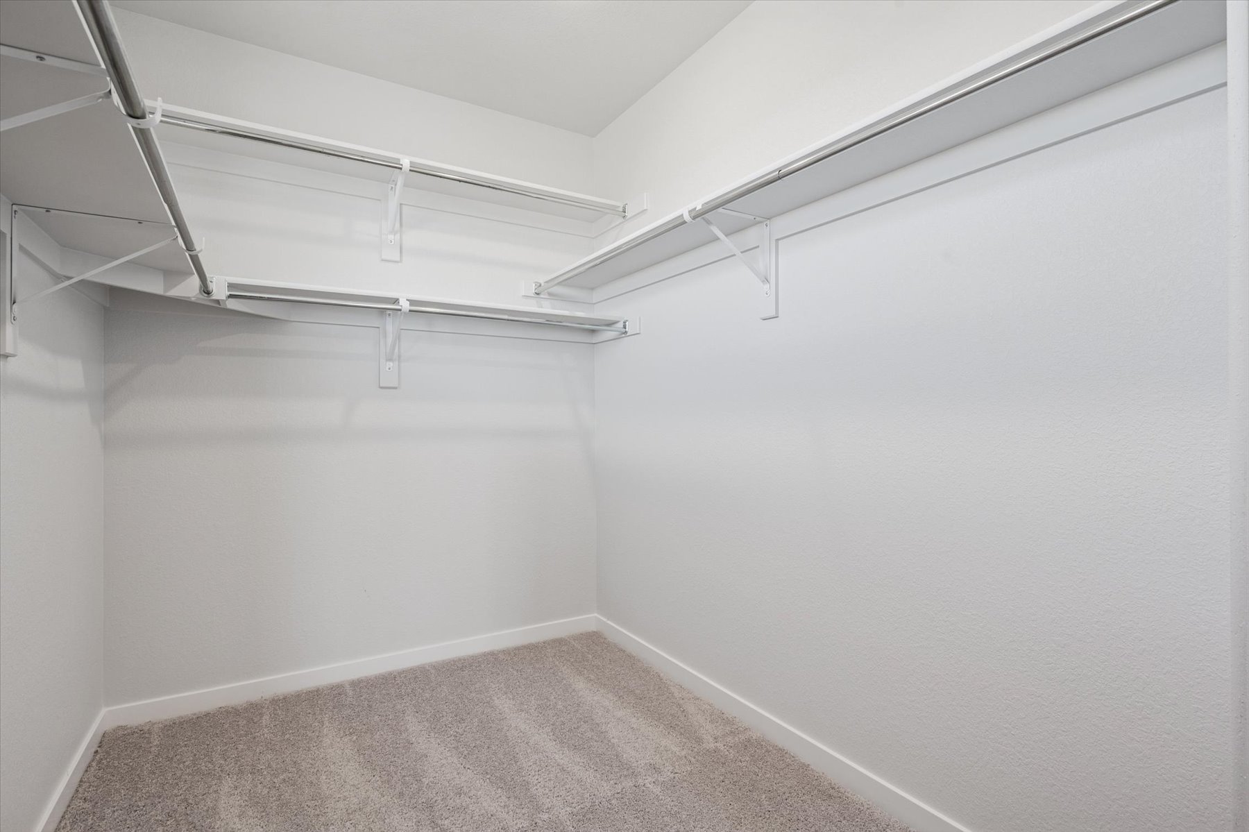 A white room with a carpet.