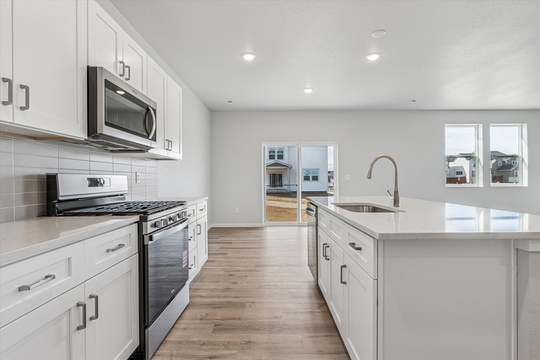 A kitchen with white cabinets.