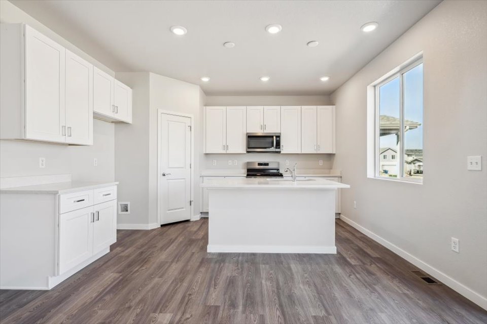 A kitchen with white cabinets.
