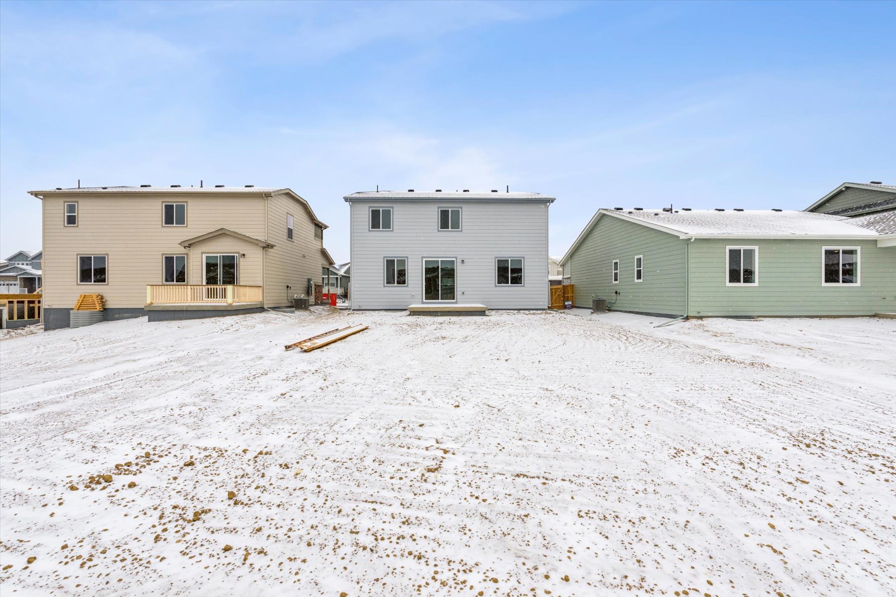 A row of houses in a snowy area.