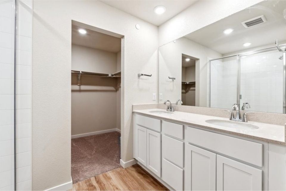 A bathroom with a large mirror.