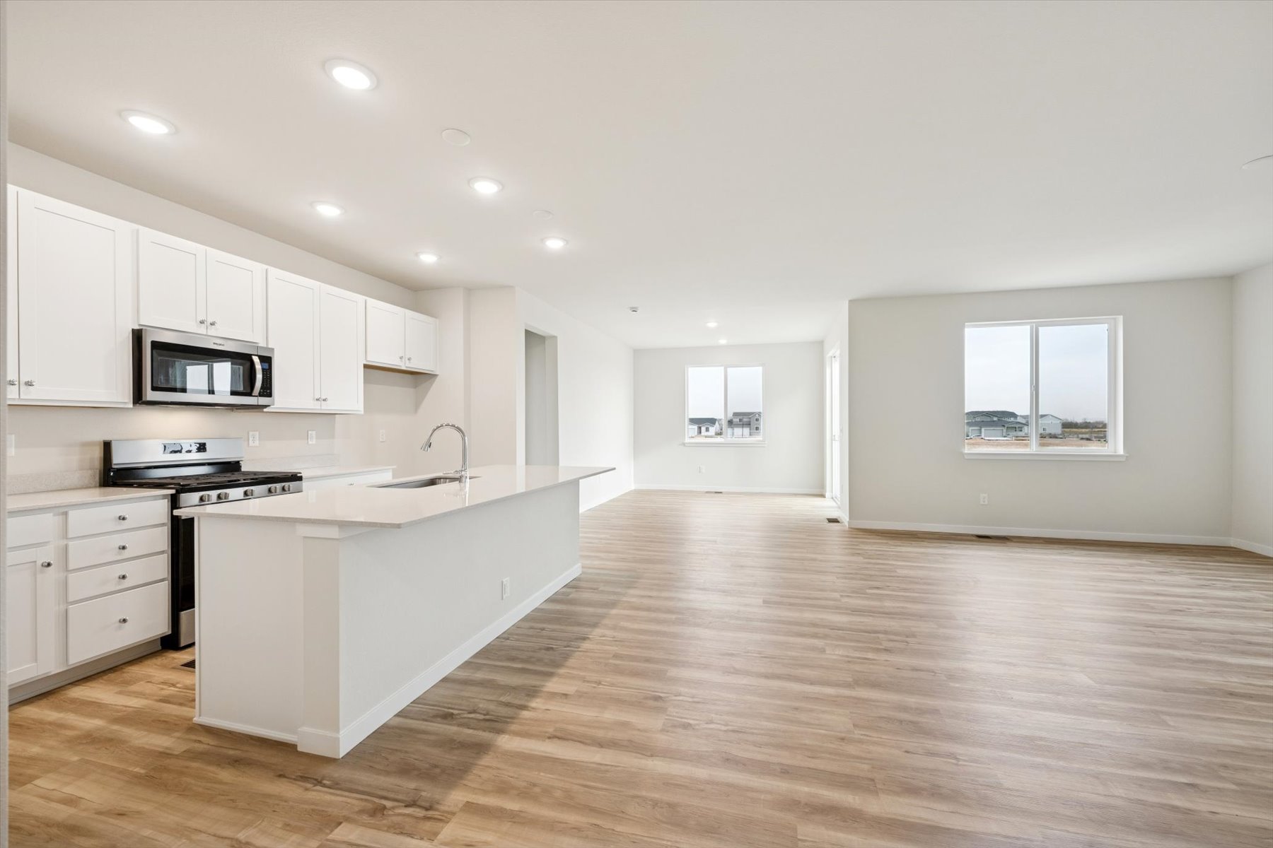A kitchen with white cabinets.