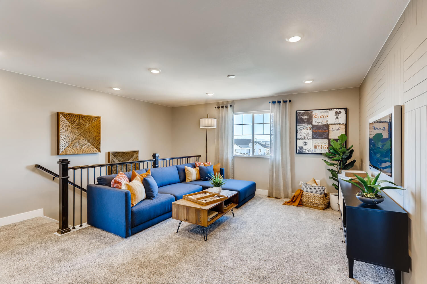 A living room with a blue couch.