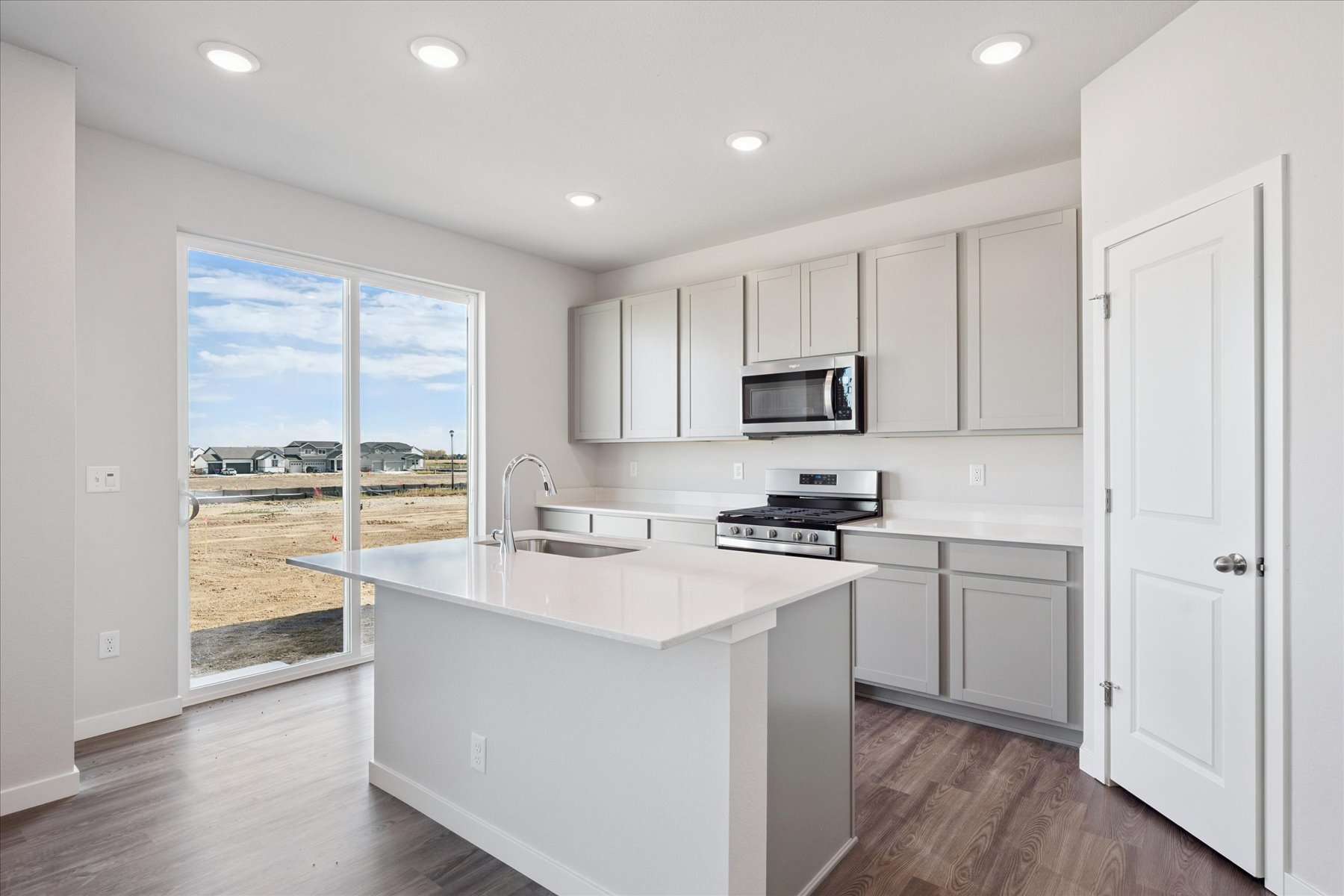 A kitchen with white cabinets.