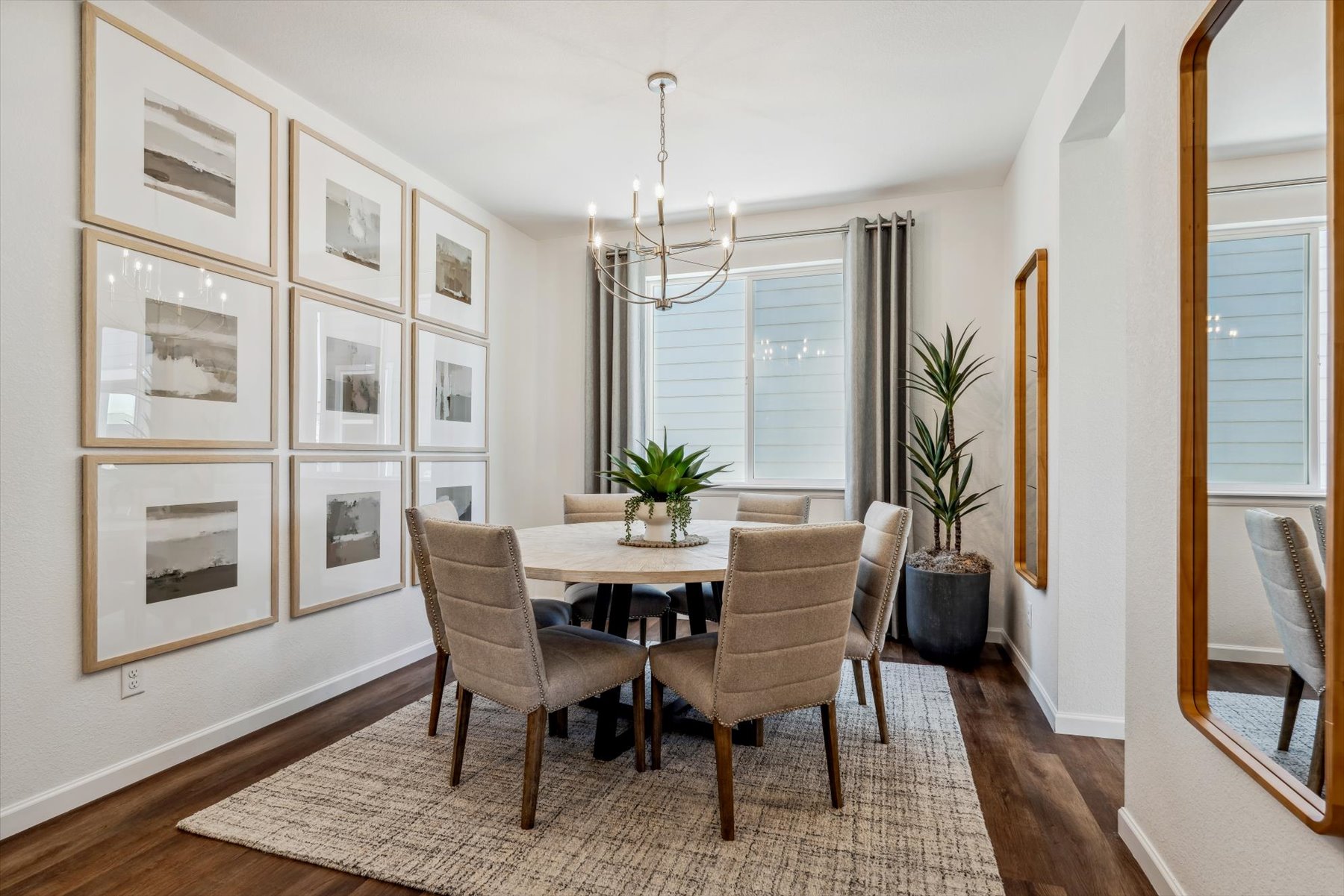 A dining room with a chandelier and a table.