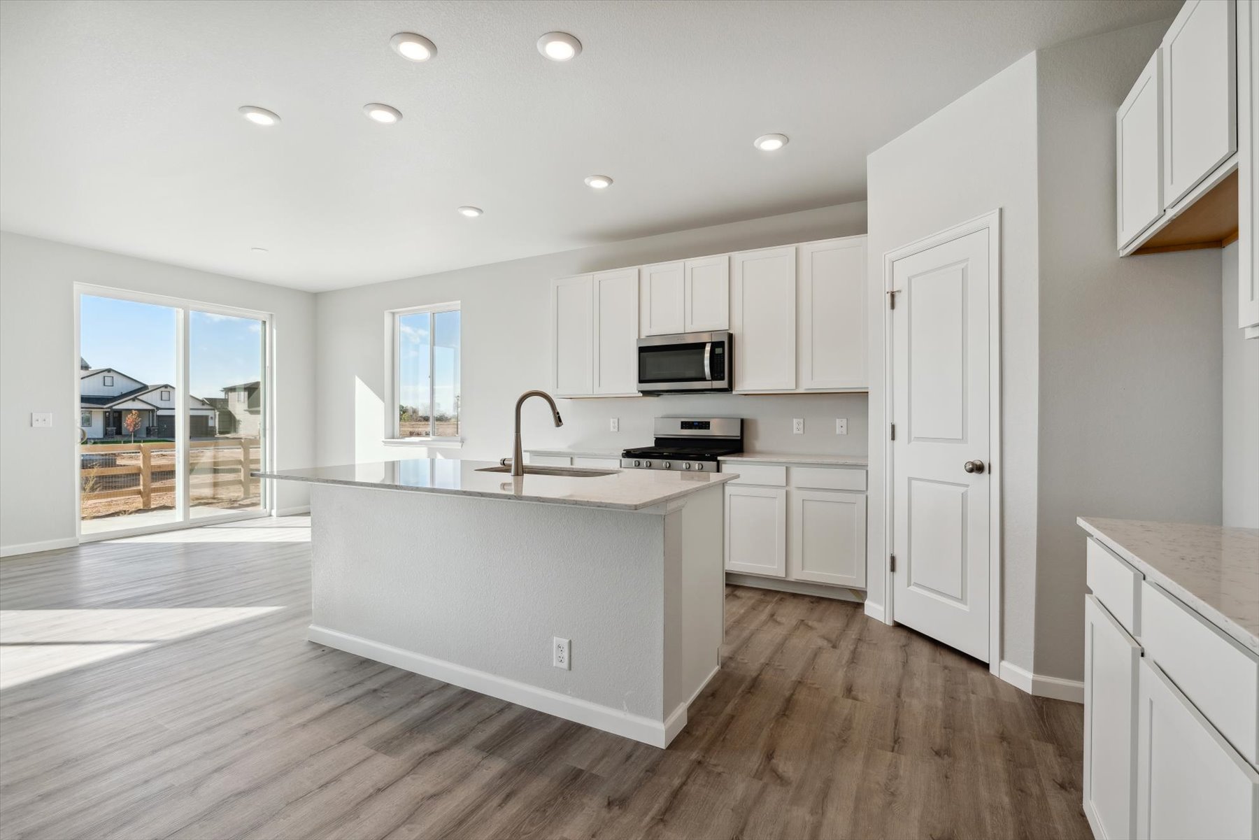 A kitchen with white cabinets.