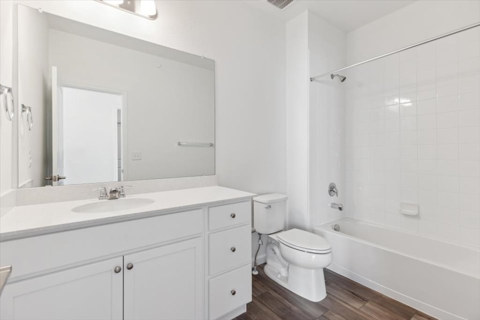 A bathroom with a tub sink and toilet.