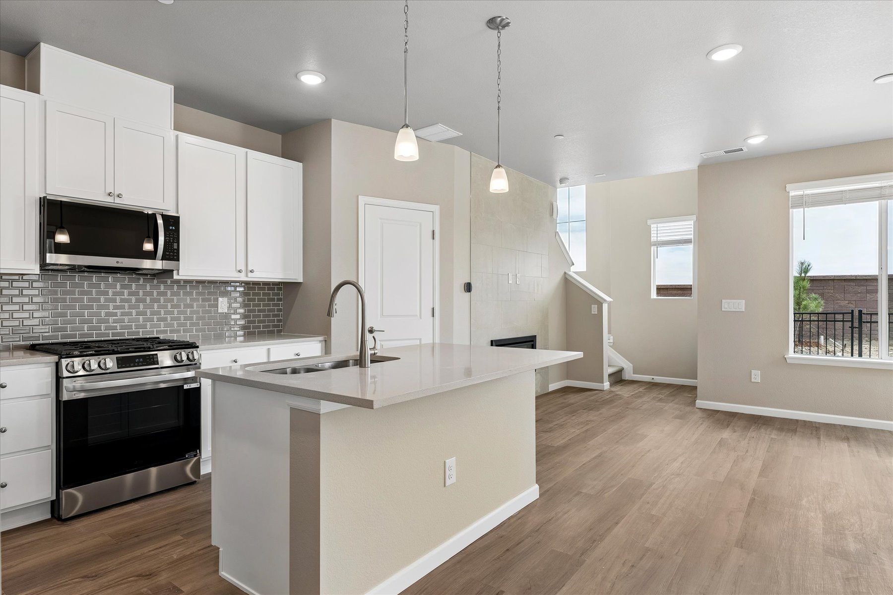 A kitchen with white cabinets.