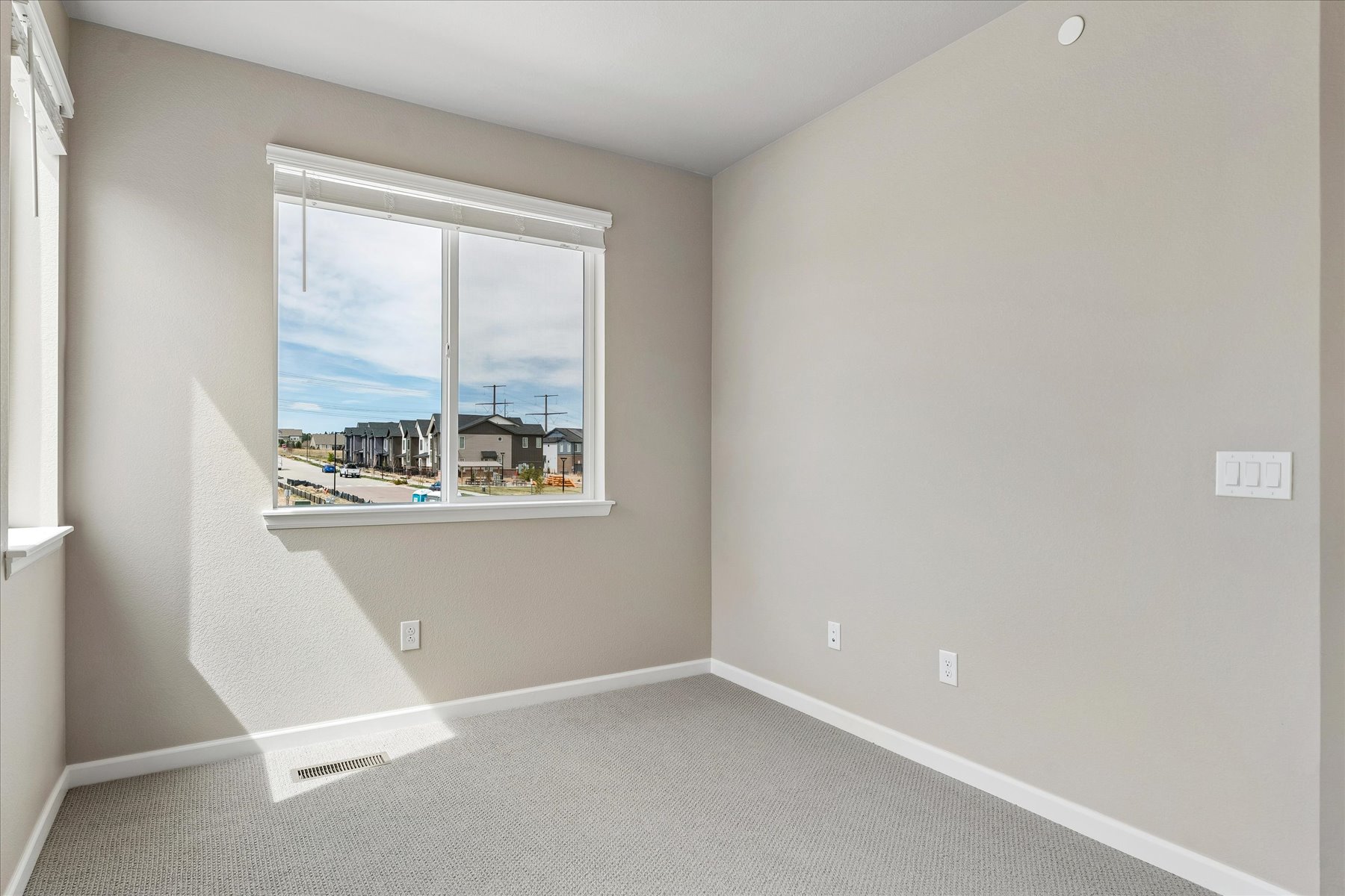 A room with a window and a view of the city.