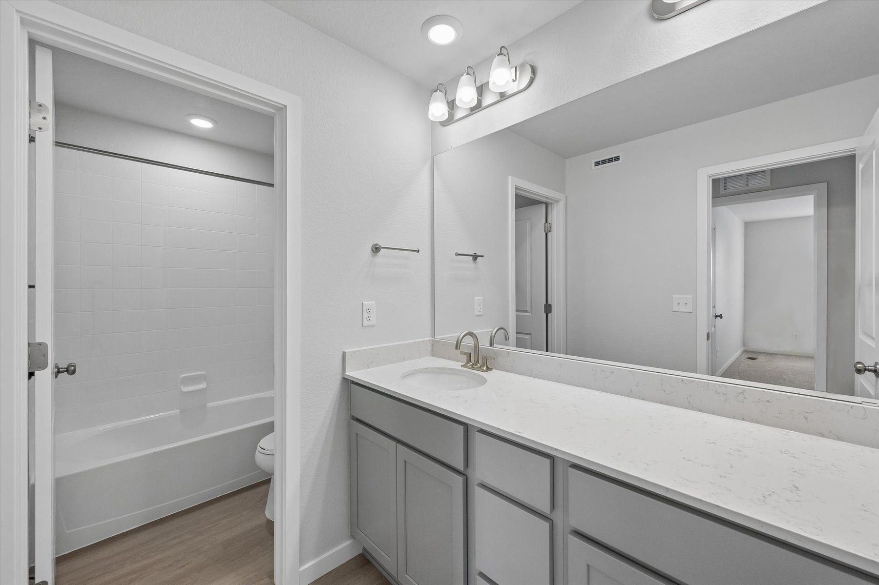 A bathroom with a tub sink and toilet.