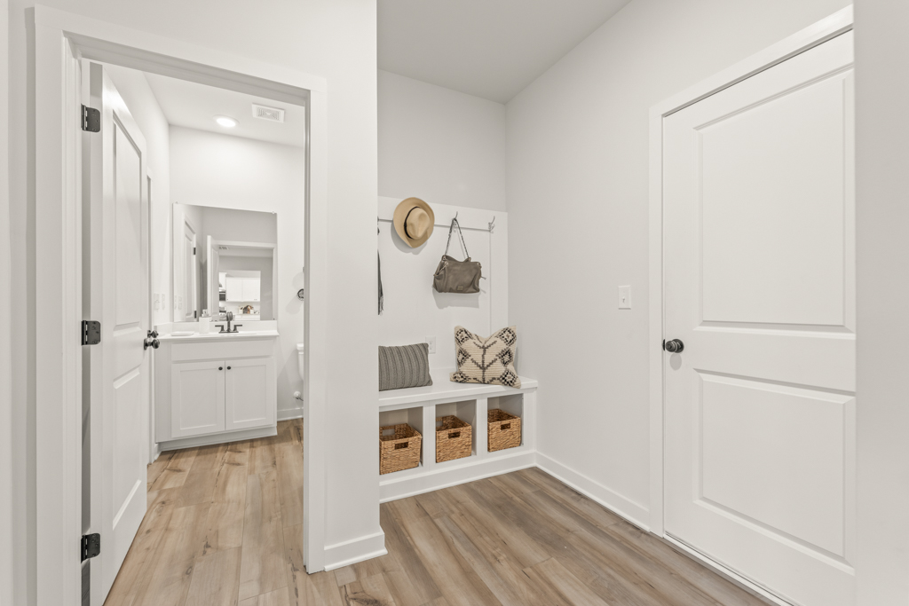 A white room with a wood floor.