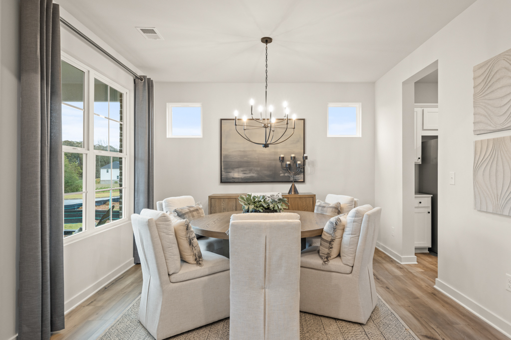 A living room with a large round table and a large round coffee table.