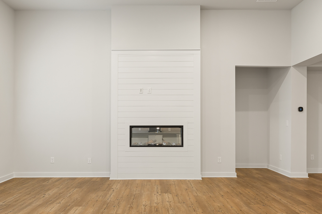 A white room with a fireplace.