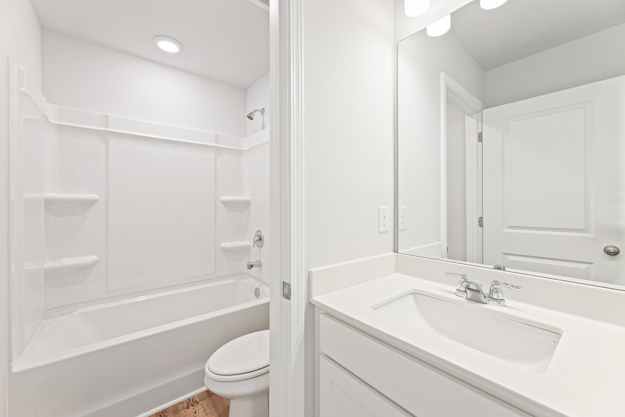 A bathroom with a tub sink and toilet.