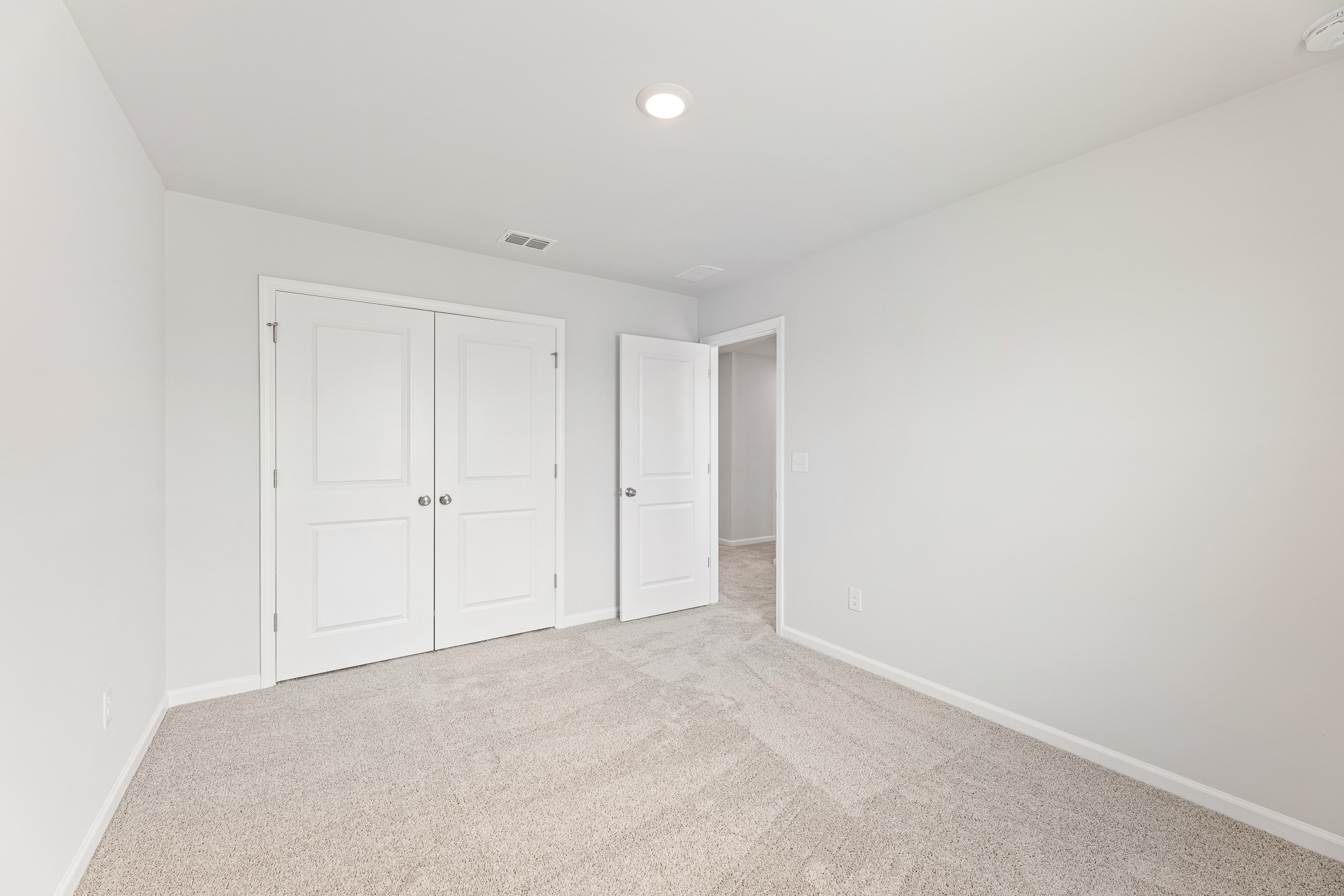A hallway with white doors.