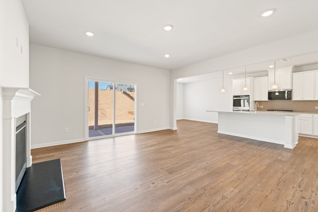 A large kitchen with white walls.